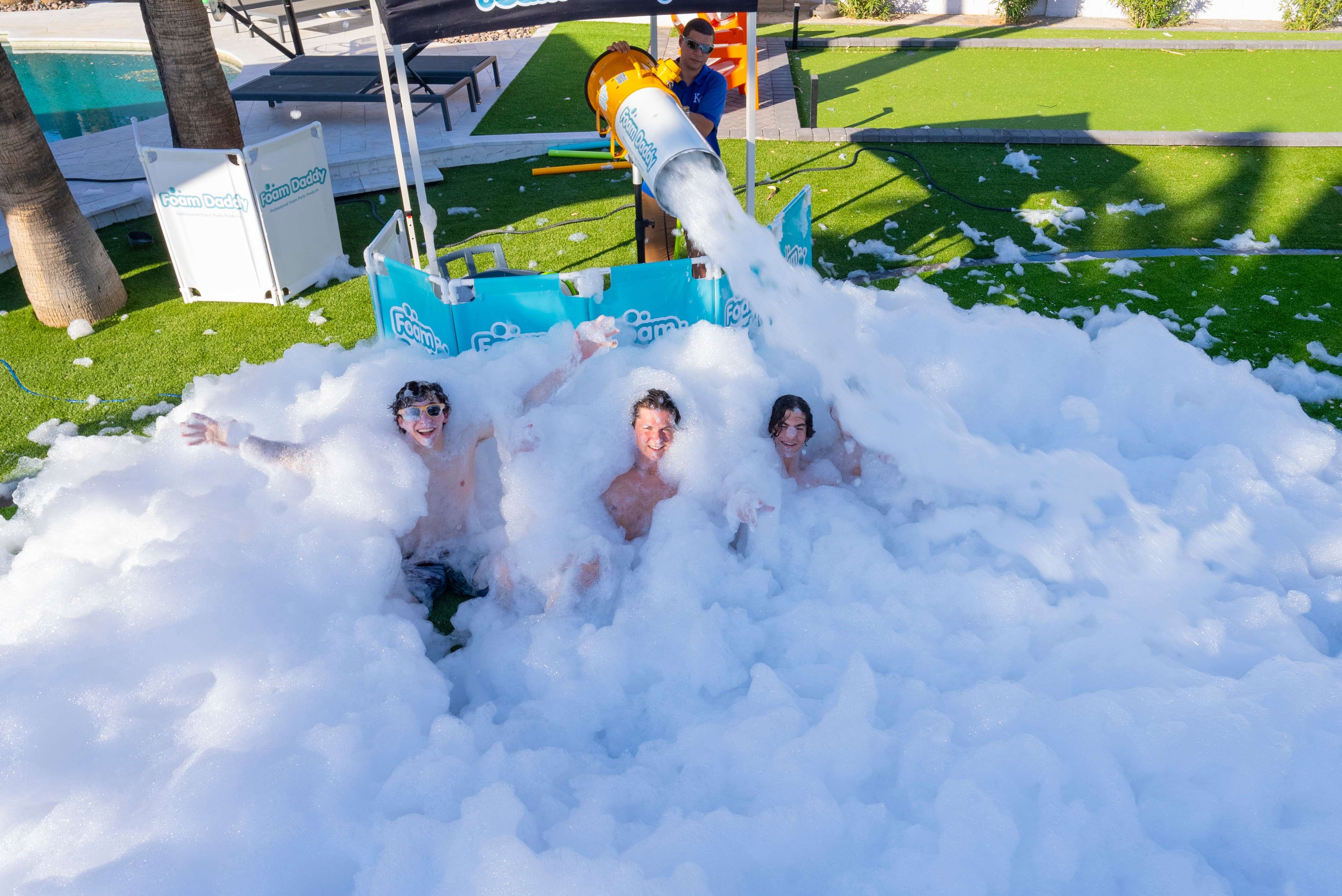 Three boys buried in foam from cannon